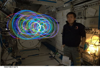 Illustration for article titled Japanese "Spiral Top" makes zero-gravity light paintings aboard the ISS